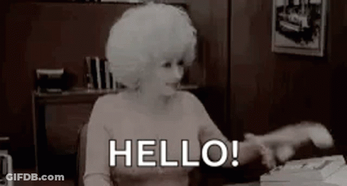 Woman With White Hair Sitting At Typewriter Saying Hello GIF