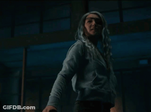 Woman With White Hair Standing Eyes Closed In Dark Room GIF