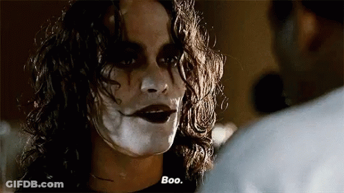 Woman With White Paint On Face Talking To Man In Dark Room GIF