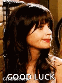 Woman With Wig And Bangs Smiling Saying Good Luck GIF