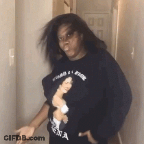 Woman With Woman Shirt And Hair Blowing In Hallway GIF