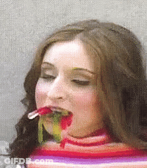 Woman With Worm Gummies In Her Mouth GIF