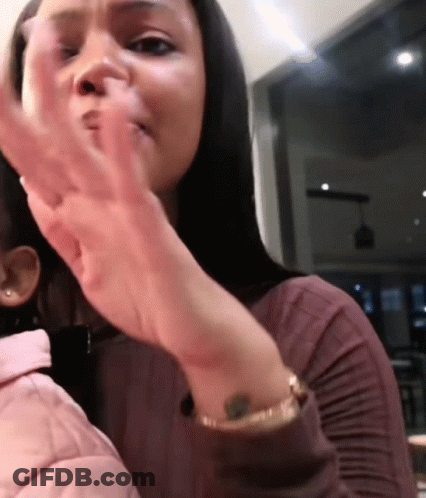 Woman With Wrist Tattoo Holding Child GIF