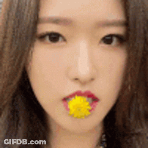 Woman With Yellow Flower In Mouth GIF