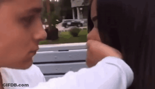 Woman With Yellow Flower In Mouth GIF
