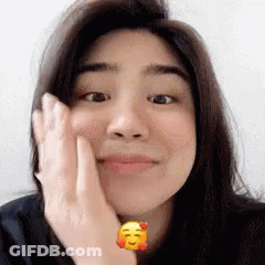 Woman With Yellow Smiley Face On Wrist GIF