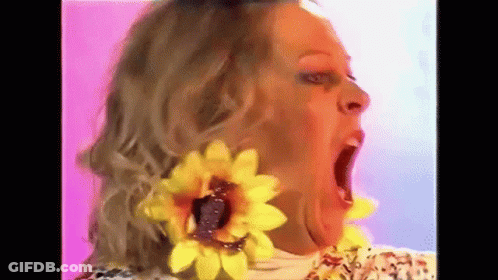 Woman With Yellow Sunflower Earrings Making Funny Face GIF