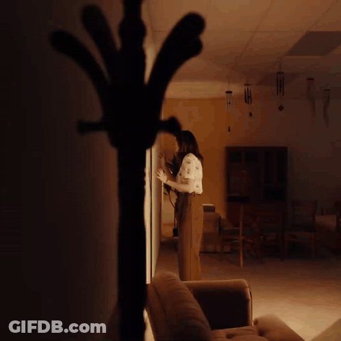 Woman With Yellow Wall GIF