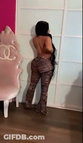 Woman Without Shirt Standing Next To Chair GIF
