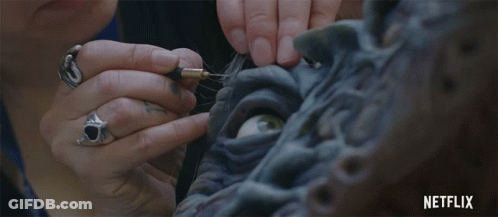 Woman Working On Statue With Netflix Logo GIF