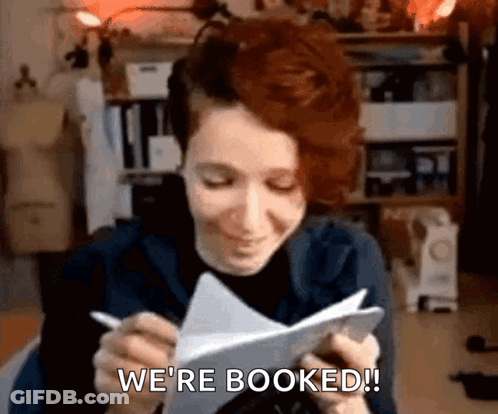Woman Writing We're Booked GIF