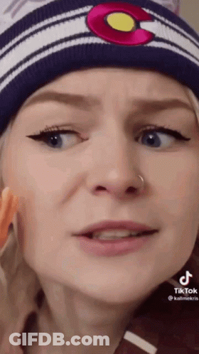 Woman Yellow Shirt On Couch Making Funny Face GIF