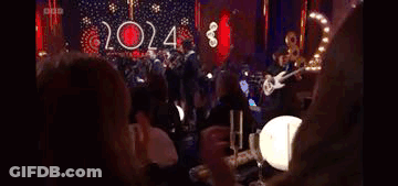 Women Clapping At Table In Dark Room GIF