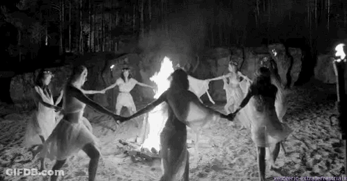 Women Dancing Around Fire On Beach GIF