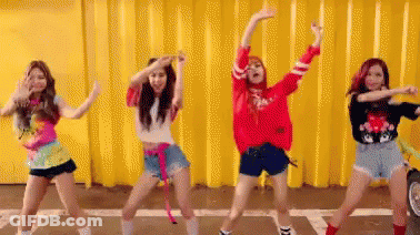 Women Dancing By Yellow Wall GIF