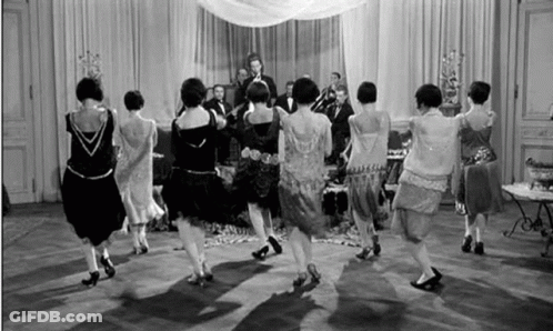 Women Dancing In Circle In Front Of Band GIF