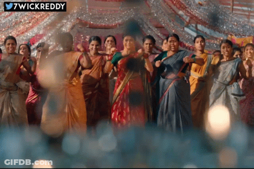 Women Dancing In Front Of 7Wickreddy Sign GIF