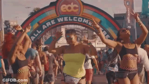 Women Dancing In Front Of EDC All Are Welcome Sign GIF