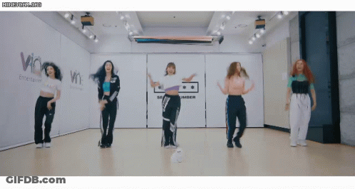 Women Dancing In Room With Amber Sign GIF
