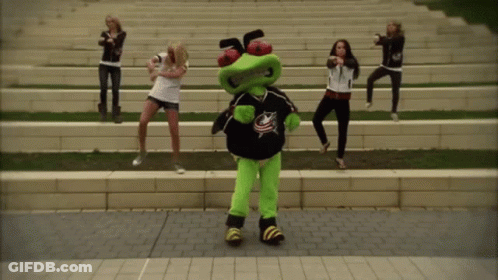 Women Dancing With Mascot In Blue Jersey GIF