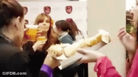 Women Drinking Beer And Eating Sandwiches GIF