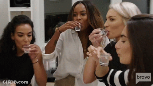 Women Drinking Shot Glasses With Bravo Logo GIF
