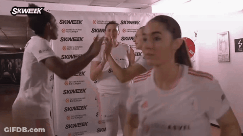 Women High-Fiving In Front Of Skweek Banner GIF