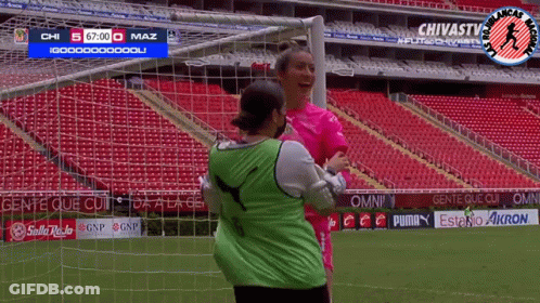 Women Hugging On Soccer Field GIF