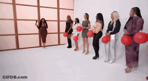 Women In A Row Holding Red Balloons GIF