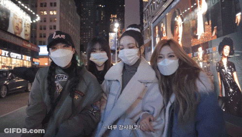 Women In Face Masks Posing In Front Of Love Building GIF