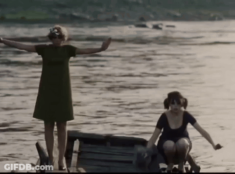 Women In Green And Black Dresses Standing In Water GIF