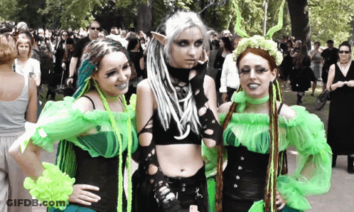 Women In Green And Black Posing For Photo GIF