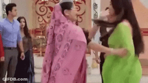 Women In Pink And Green Dresses Standing GIF