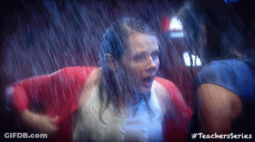 Women In Red Jackets Standing In Rain GIF