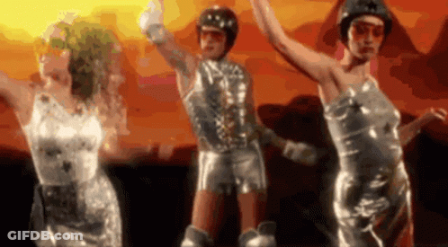 Women In Silver Dresses Dancing In Front Of Sunset GIF