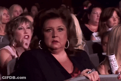 Women In Theater Watching Show Holding RLC Ticket GIF