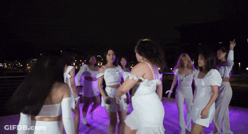 Women In White Dresses Dancing In Circle At Night GIF