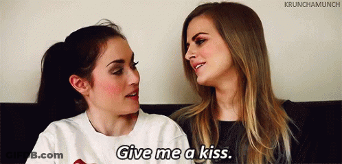 Women Looking At Each Other Asking For Kiss GIF