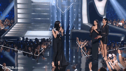 Women On Stage In Front Of Crowd GIF
