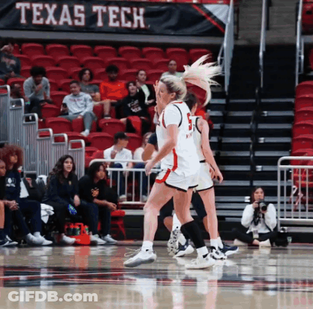 Women Playing Basketball In Front Of A Banner That Says " Texas Tech " GIF