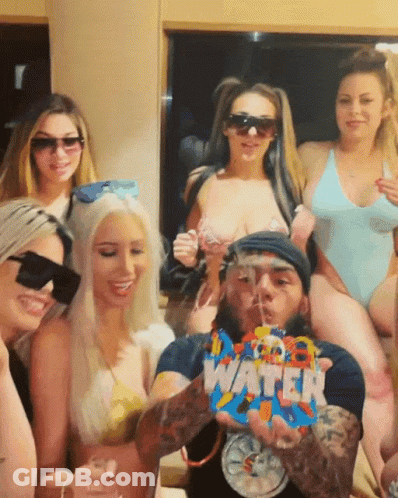 Women Posing With Man Holding Water Bag GIF