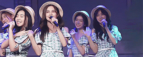Women Singing Into Microphones Wearing Straw Hats GIF
