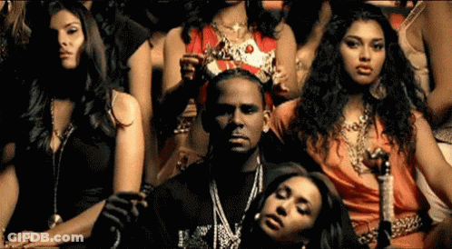 Women Sitting Around Man In Crown GIF