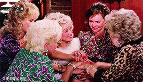Women Sitting Around Table Hands On Wrists GIF