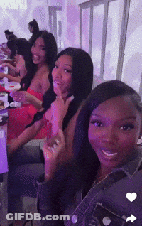 Women Sitting At Table With Purple Lights GIF