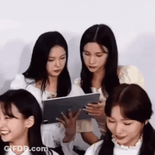 Women Sitting At Table With Tablet GIF