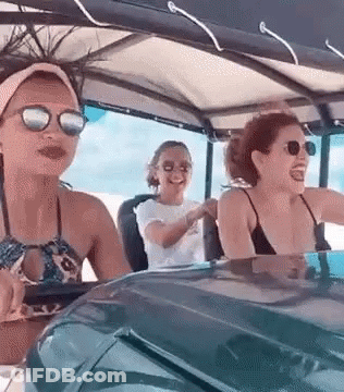 Women Sitting In Golf Cart On Beach GIF