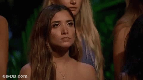 Women Sitting In Row, One Looking At Camera GIF