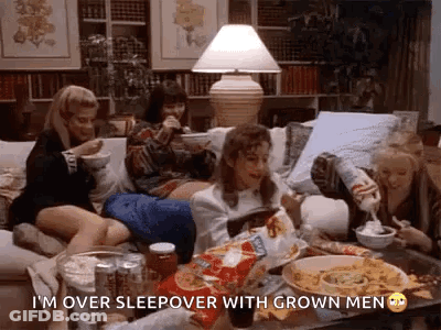 Women Sitting On Couch Eating Chips And Drinking Soda GIF