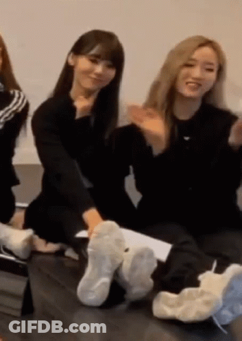 Women Sitting On Couch With Feet In Shoes GIF